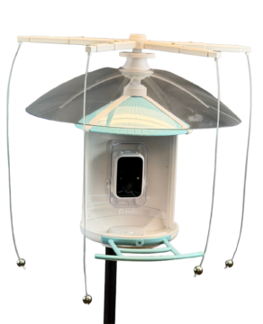 A smart feeder covered with a weather guard and a sparrow spooker